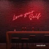 Love Yourself neon sign in red for self-love decor, beauty rooms, and empowering spaces.
