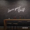 Love Yourself neon sign in white for self-love decor, beauty rooms, and empowering spaces.