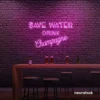 Save Water Drink Champagne neon sign in pink for party kitchens, wine bars, and bubbly wall decor.