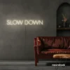 Slow Down neon sign in neutral white for relaxation spaces, wellness decor, and mindful interiors.