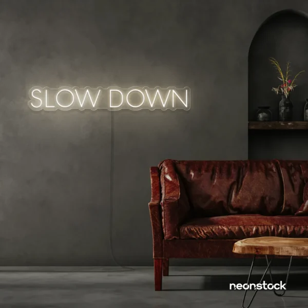 Slow Down neon sign in neutral white for relaxation spaces, wellness decor, and mindful interiors.