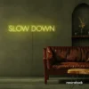 Slow Down neon sign in ice blue for relaxation spaces, wellness decor, and mindful interiors.
