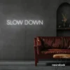 Slow Down neon sign in white for relaxation spaces, wellness decor, and mindful interiors.