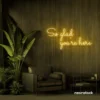 So Glad You Are Here neon sign in golden yellow for entryways, restaurant walls, and welcoming interiors.