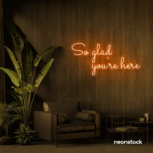 So Glad You Are Here neon sign in orange for entryways, restaurant walls, and welcoming interiors.