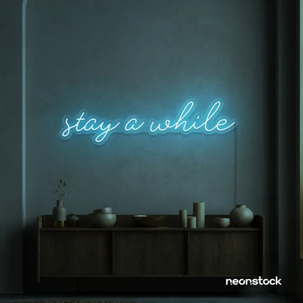 Stay Awhile neon sign in ice blue for cozy cafes, home decor, and hospitality settings.