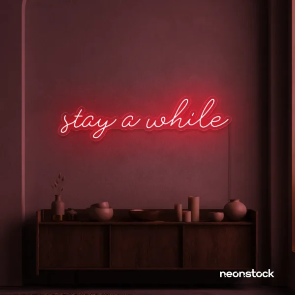 Stay Awhile neon sign in red for cozy cafes, home decor, and hospitality settings.