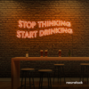 Stop Thinking Start Drinking neon sign in orange for bar walls, man caves, and party spaces.