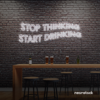 Stop Thinking Start Drinking neon sign in white for bar walls, man caves, and party spaces.