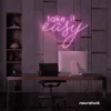 Take It Easy neon sign in baby pink for chill wall decor, boho rooms, and relaxed interiors.