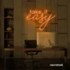 Take It Easy neon sign in orange for chill wall decor, boho rooms, and relaxed interiors.