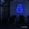 This Must Be The Place neon sign in dark blue for cozy salons, boutique shops, and cafe decor.