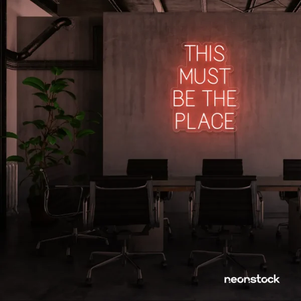 This Must Be The Place neon sign in peachy pink for cozy salons, boutique shops, and cafe decor.