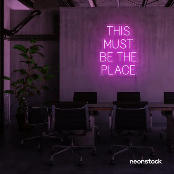 This Must Be The Place neon sign in pink for cozy salons, boutique shops, and cafe decor.
