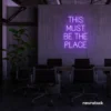 This Must Be The Place neon sign in purple for cozy salons, boutique shops, and cafe decor.