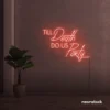 Neon sign text 'Till Death Do Us Party' in peachy pink for wedding decor, romantic event signage, party celebration