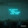 Neon sign text 'We should hang something cool here' in mint green for wall art and home decor