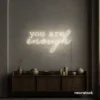 You Are Enough neon sign in neutral white for self-love decor, therapy rooms, and calm spaces.
