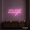 You Are Enough neon sign in baby pink for self-love decor, therapy rooms, and calm spaces.