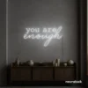 You Are Enough neon sign in white for self-love decor, therapy rooms, and calm spaces.